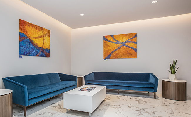 4DR downlights illuminating a modern sitting area with blue couches, marble floor, and white coffee table.