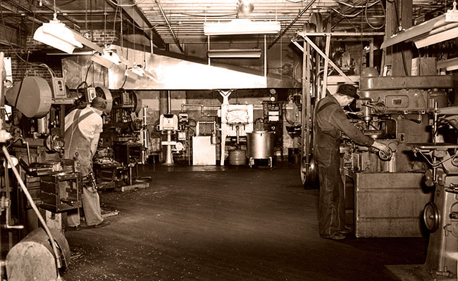 The Williams factory floor in the 1940s with machinists at work