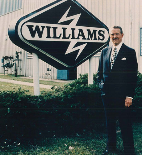 John Williams in front of the 80s Williams sign